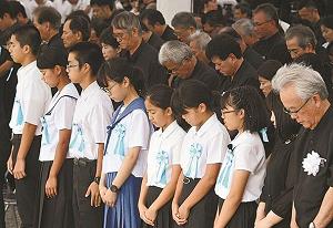 沖縄全戦没者追悼式で黙禱する参列者を写した写真